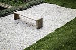 Wooden Bench In Rock Garden Stock Photo