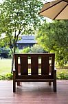 Wooden Chair In The Green Garden Stock Photo