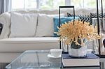 Yellow Flower In Glass Vase And Book  On Glass Table In Living R Stock Photo