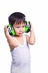 Young Asian Boy In A White Singlet Wearing Earmuffs Stock Photo