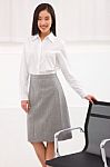 Young Asian Businesswoman Standing Near Chair Stock Photo