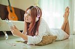 Young Asian Woman Listening To Music Stock Photo