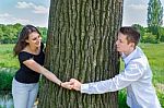 Young Attractive Caucasian Couple In Love Holding Hands Around T Stock Photo