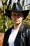 Young Attractive Man In A Black Leather Coat And Hat Stock Photo