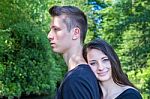 Young Attractive Woman Leaning Head On Back Of Man Stock Photo