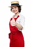 Young Baker Woman Gesturing Thumbs Up Stock Photo