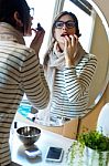 Young Beautiful Woman Making Up Her Face Stock Photo