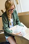 Young Beautiful Woman Moving In A New Home Stock Photo