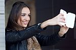 Young Beautiful Woman Taking A Selfie In The Street Stock Photo