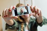 Young Beautiful Woman Taking A Selfie With Smartphone In Her New Stock Photo