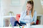 Young Beautiful Woman Using Her Digital Tablet At Home Stock Photo