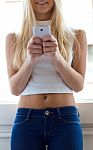 Young Beautiful Woman Using Her Mobile Phone At Home Stock Photo