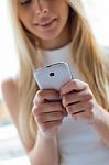 Young Beautiful Woman Using Her Mobile Phone At Home Stock Photo