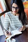 Young Beautiful Woman Using Her Mobile Phone In Coffee Stock Photo