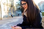 Young Beautiful Woman Using Her Mobile Phone In The Street Stock Photo