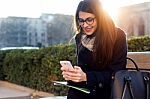 Young Beautiful Woman Using Her Mobile Phone In The Street Stock Photo