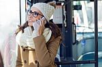 Young Beautiful Woman Using Her Mobile Phone On A  Bus Stock Photo