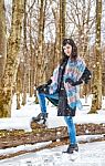 Young Beautiful Woman Walking Under A Snowfall Stock Photo