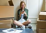 Young Beautiful Woman With Mobile Phone In Her New House Stock Photo