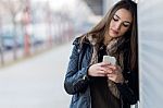 Young Beautiful Woman With Mobile Phone In The Street Stock Photo