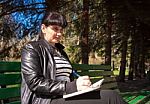 Young Beautiful Woman Writing A Pen In Notebook Stock Photo