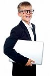 Young Boy Carrying Laptop Stock Photo