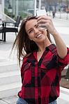 Young Brunette With A Smart Phone Stock Photo