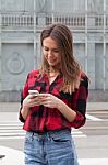 Young Brunette With A Smart Phone Stock Photo