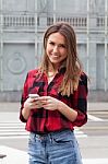 Young Brunette With A Smart Phone Stock Photo