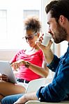 Young Business Man Drinking Coffee And Business Woman Using Tabl Stock Photo