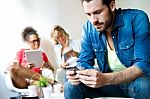 Young Business Man Using His Mobile Phone, In The Background Bus Stock Photo