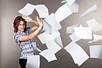 Young Business Woman With Flying Documents Stock Photo