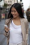 Young Business Women Looking At Cell Phone Stock Photo