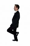 Young Businessman Benting One Leg Stock Photo