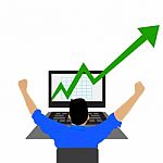 Young Businessman Looking At A Stock Market Graph With Growth Arrow  Stock Photo