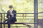 Young Businessman Looking At Report Paper Stock Photo