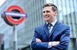 Young Businessman Standing In Front Of Buildings Stock Photo