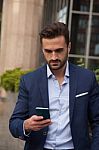 Young Businessman Using His Mobile Phone Stock Photo