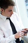 Young Businessman Using His Mobile Phone In Office Stock Photo