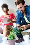 Young Businessman Using The Mobile Phone And Business Woman Usin Stock Photo