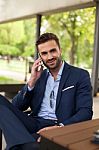 Young Businessmen With Cell Phone Outside Stock Photo