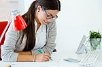 Young Businesswoman Working In Her Office With Laptop Stock Photo