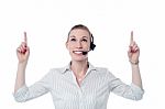 Young Call Center Woman Pointing Up Stock Photo