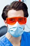 Young Caring Dentist With Red Glasses Stock Photo