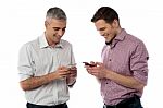 Young Casual Men Using Their Smart Phone Stock Photo