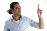 Young Caucasian Man Pointing Upwards Stock Photo