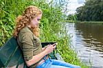 Young Caucasian Woman Operates Mobile Phone Stock Photo