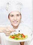 Young Chef Decorating Delicious Salad Stock Photo