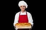 Young Chef Holding Big Bread Stock Photo