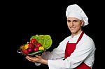 Young Chef Holding Colander With Fresh Vegetables Stock Photo